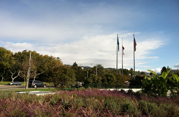 The entry to the structure is shielded from view by massed colorful (and water-wise) shrubs.