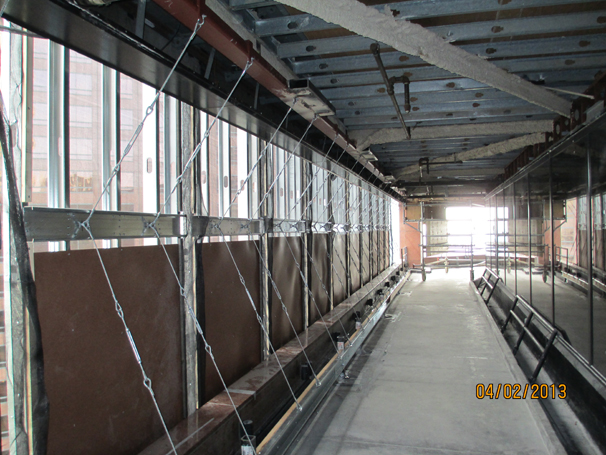 Wood panels provide fall protection for the workers, as well as protection from items falling below.