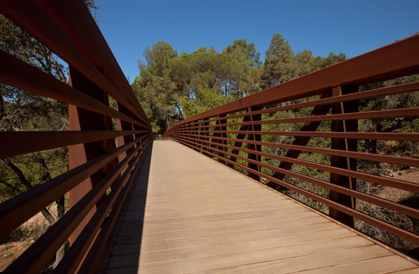 This Corten steel bridge permits pedestrians to cross over--or stop to view--a protected riparian habitat.