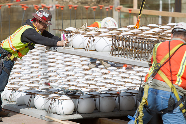 Workers place BubbleDeck slabs